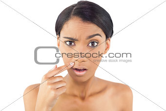 Gorgeous woman pointing at wrinkle above her lip