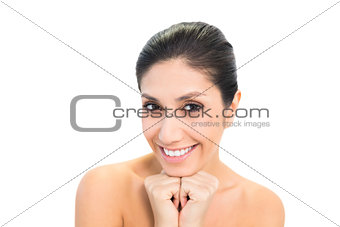 Smiling brunette with hands together under her chin