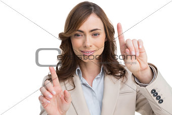 Classy businesswoman touching invisible screen