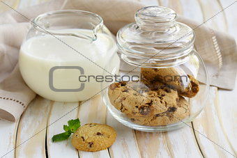 breakfast cookies with chocolate and milk on a wooden table