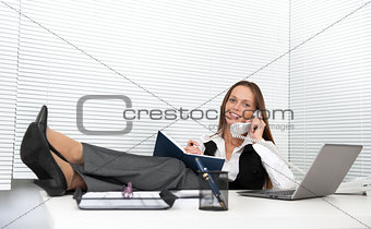 cute young office worker talking on phone in office