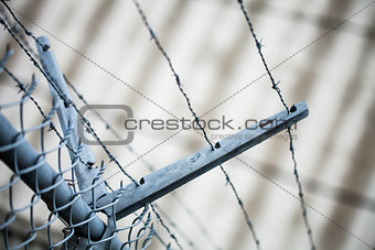 Outdoor Fence Detail of Sharp Barbwire Installation.