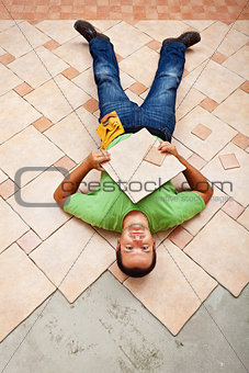 Worker resting on ceramic floor tiles