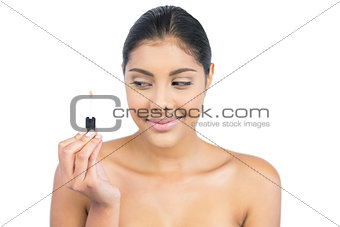 Content nude brunette holding lip gloss