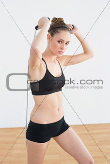 Beautiful fit woman skipping using a rope