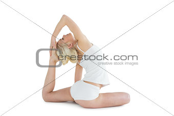 Side view of toned woman doing the pigeon pose
