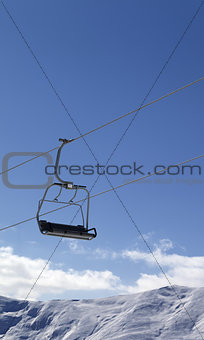 Chair lift and snowy mountains at nice day