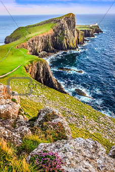 Vertical view of Neist Point lighthouse and rocky ocean coastlin