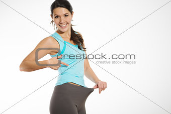 Athletic woman showing off her weight loss