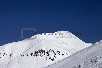 Ski slope and ropeway at nice winter day