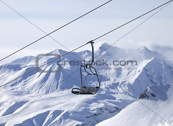 Chair lifts and off-piste slope in fog