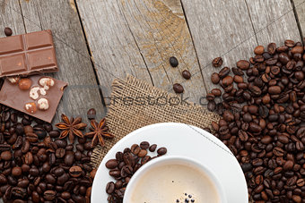 Coffee cup and chocolate on wooden table
