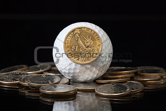 White golf ball and U.S. dollar coins