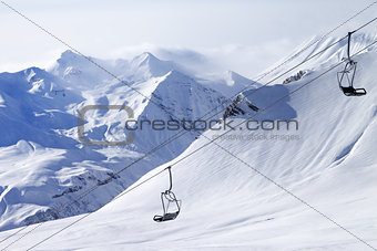Chair lifts and off-piste slope in haze