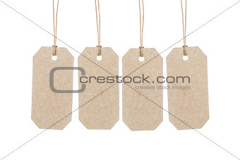four brown tags hanging on ropes