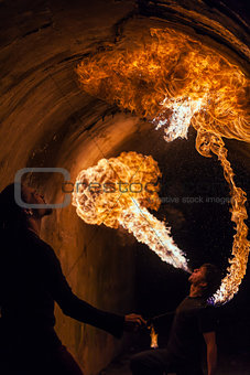 Young man blowing fire from his mouth