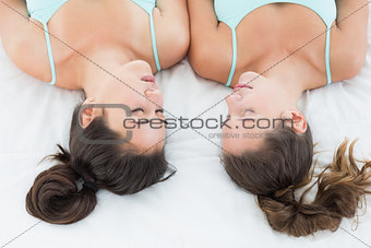 Close-up of two female friends sleeping in bed