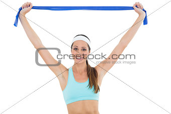 Smiling fit young woman with a blue yoga belt