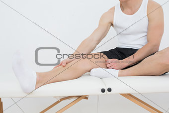 Man sitting on examination table in medical office