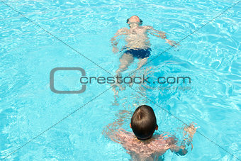two happy friends swimming in the pool