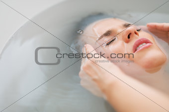 Portrait of stressed young woman in bathtub