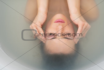 Portrait of stressed young woman in bathtub