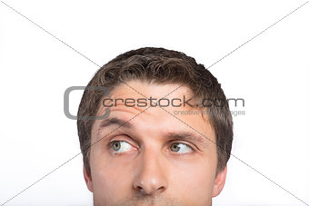 Close-up of a green eyed man raising eyebrow