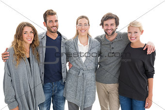 Group portrait of happy people standing with arms around