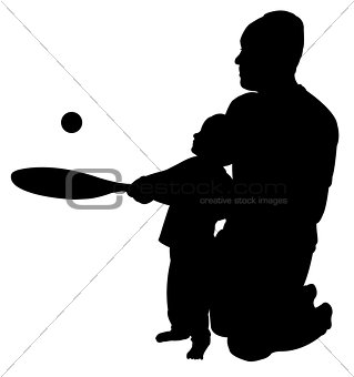 father playing teaching to play tennis to his son