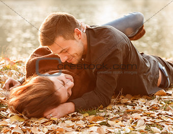 young couple lying down smiling