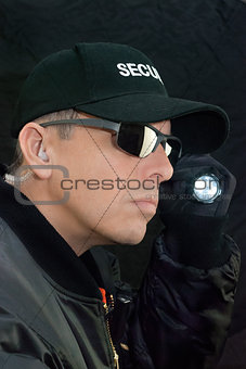 Security Guard Searches With Flashlight