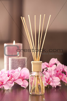 air freshener sticks at home with flowers and ou of focus backgr