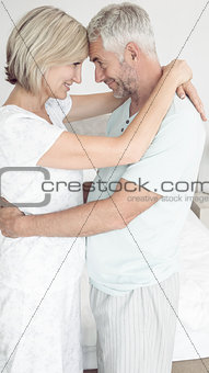 Loving mature couple with arms around