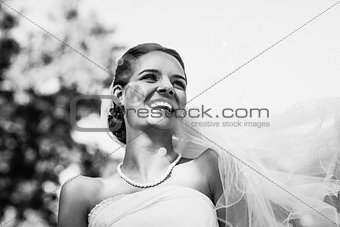 Close-up of cheerful beautiful bride in park