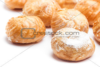 Cream puffs on white background