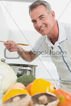Man preparing food with vegetables in the foreground