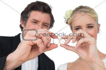 Bride and groom looking at wedding rings