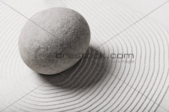 stone in the sand and circles around him