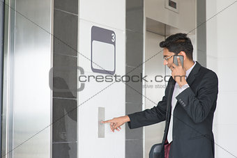 Indian businessman entering elevator