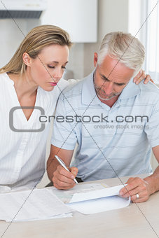 Serious couple working out their finances