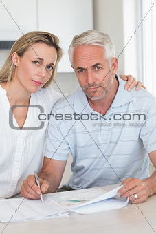 Worried couple working out their finances