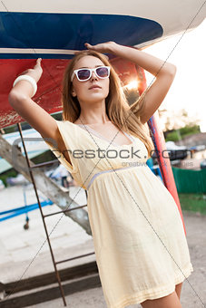 beautiful girl in summer dress at sea pier