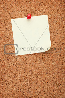 Blank postit note on cork notice board