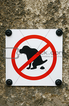 No Dog Pooping sign isolated on wall background