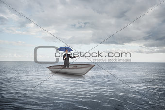 Composite image of peaceful businessman holding blue umbrella in a sailboat