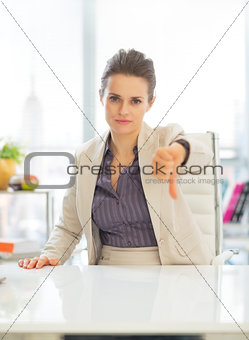 Business woman showing thumbs down