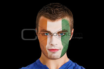 Serious young ivory coast fan with facepaint