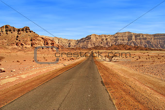Road through red mountains in Israel.