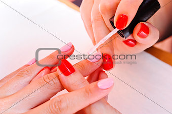 Skin and nail care. Applying of the Transparent varnish. 