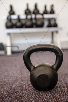 Black kettlebell on the weights room floor